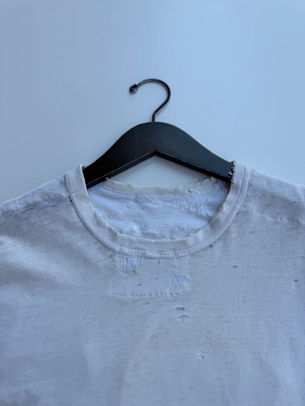 thoroughly repaired white t-shirt